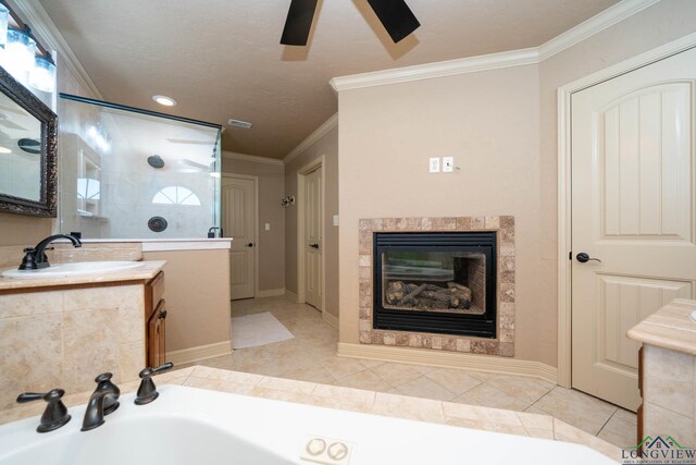111 Winifreds Way, Hallsville, TX 75650 - full bathroom featuring tile patterned flooring, vanity, a walk in shower, crown molding, and a glass covered fireplace