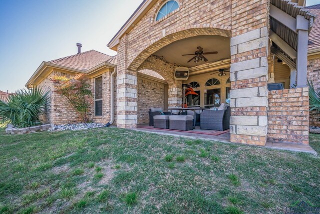 111 Winifreds Way, Hallsville, TX 75650 - property entrance featuring brick siding, outdoor lounge area, a ceiling fan, a lawn, and a patio