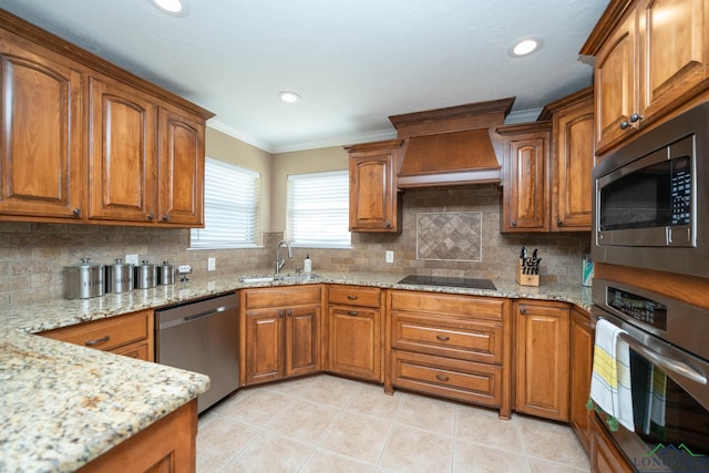 111 Winifreds Way, Hallsville, TX 75650 - kitchen with brown cabinetry, a sink, appliances with stainless steel finishes, and custom range hood