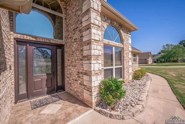 111 Winifreds Way, Hallsville, TX 75650 - doorway to property with brick siding