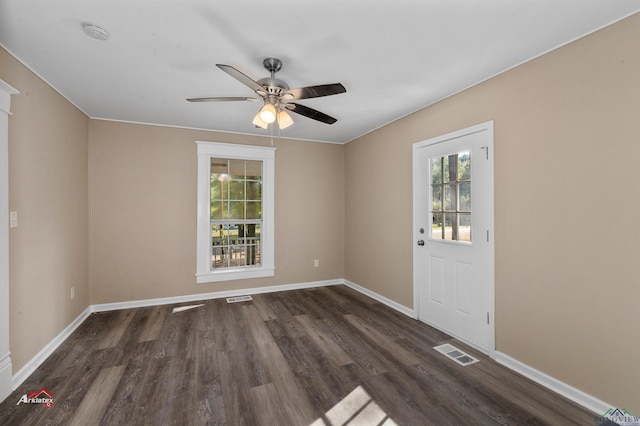 spare room featuring dark hardwood / wood-style flooring and ceiling fan