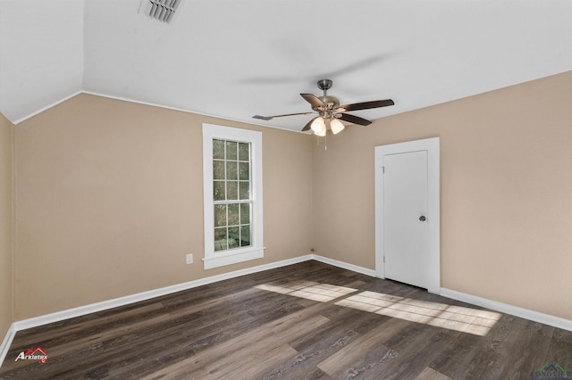 spare room with dark hardwood / wood-style flooring, ceiling fan, and lofted ceiling