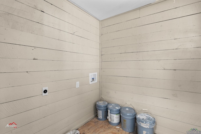 clothes washing area with wood walls, hookup for a washing machine, and hookup for an electric dryer