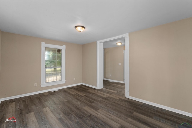 unfurnished room featuring dark hardwood / wood-style flooring