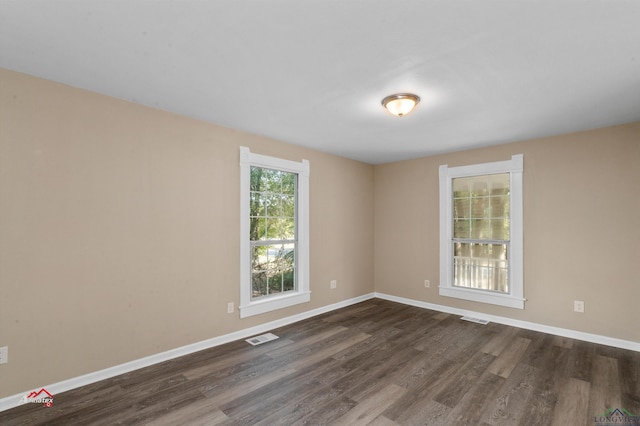 empty room with dark hardwood / wood-style floors