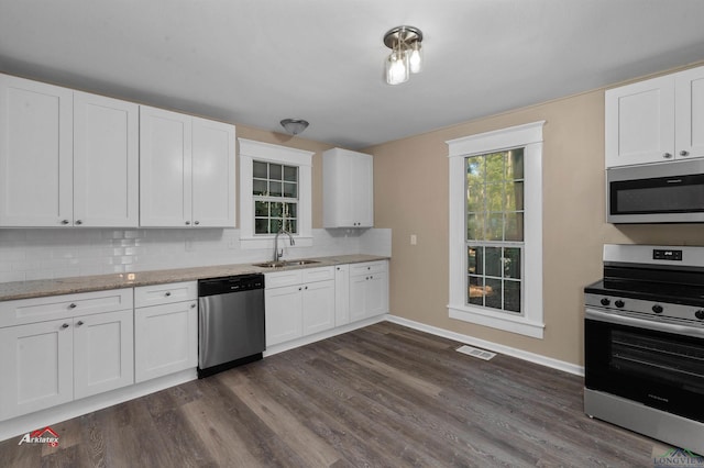 kitchen with white cabinets, stainless steel appliances, and sink