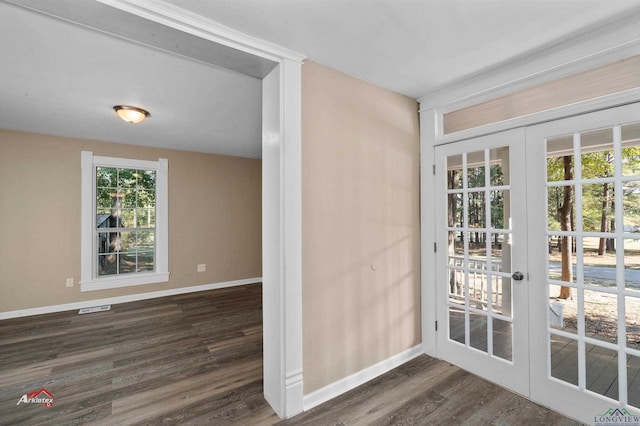 doorway with a healthy amount of sunlight, dark hardwood / wood-style flooring, and french doors