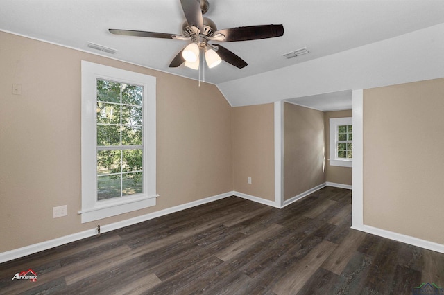 additional living space featuring ceiling fan, dark hardwood / wood-style flooring, lofted ceiling, and a wealth of natural light