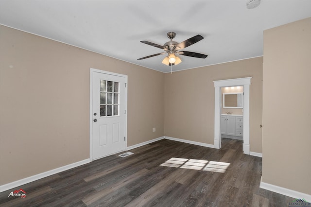 empty room featuring ceiling fan and dark wood-type flooring