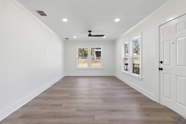 spare room with crown molding, light hardwood / wood-style flooring, and ceiling fan