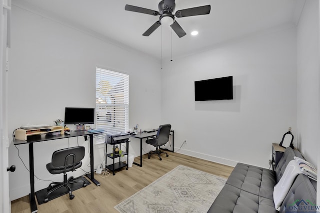 office space with crown molding, ceiling fan, and light hardwood / wood-style flooring