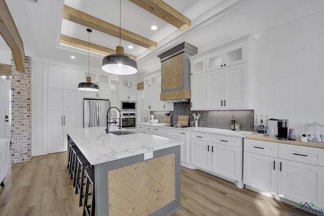 kitchen featuring tasteful backsplash, decorative light fixtures, white cabinets, and appliances with stainless steel finishes