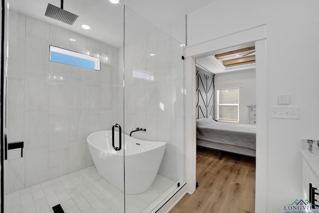 bathroom featuring wood-type flooring, separate shower and tub, and tile walls