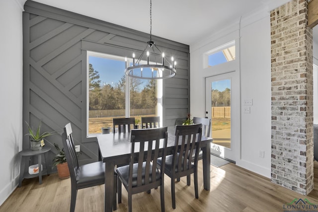 dining area featuring a notable chandelier and hardwood / wood-style flooring