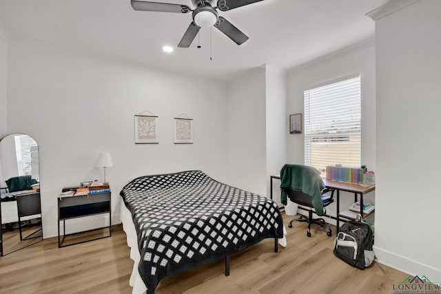 bedroom featuring crown molding, light hardwood / wood-style floors, and ceiling fan