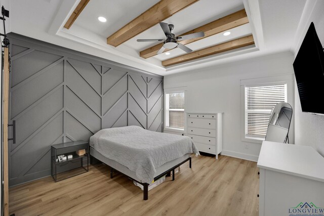 bedroom featuring multiple windows, crown molding, light wood-type flooring, and ceiling fan