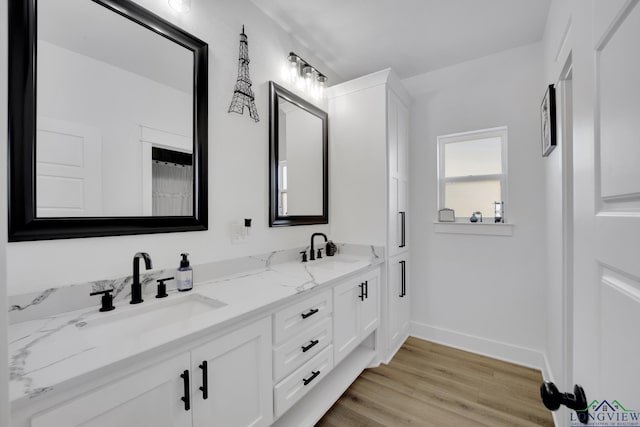 bathroom featuring hardwood / wood-style flooring and vanity