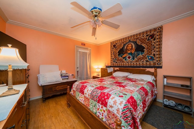 bedroom with ceiling fan, wood finished floors, baseboards, and ornamental molding