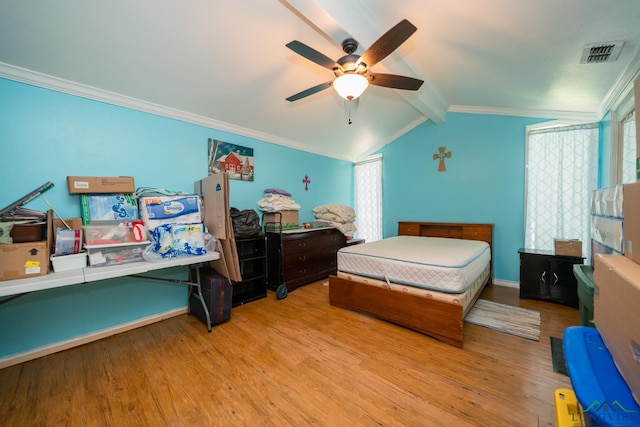 bedroom with visible vents, light wood-style floors, and ornamental molding