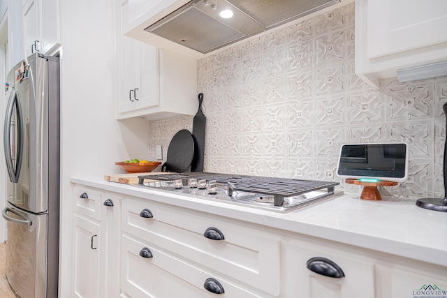 kitchen with white cabinets, custom exhaust hood, backsplash, and appliances with stainless steel finishes