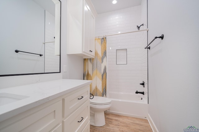 full bathroom featuring shower / bath combination with curtain, toilet, wood-type flooring, and vanity