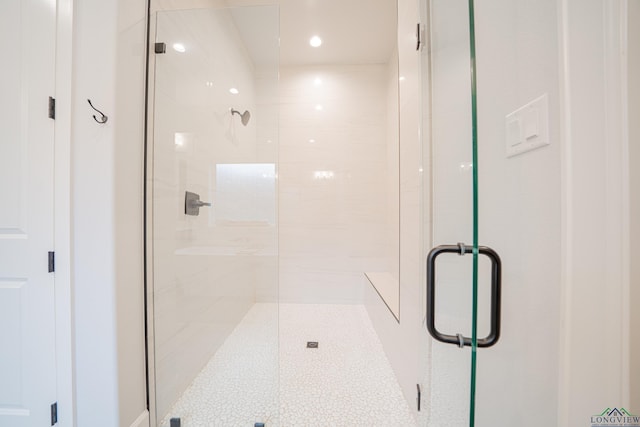 bathroom featuring a shower with shower door