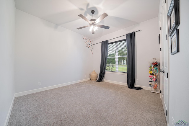 carpeted spare room with ceiling fan