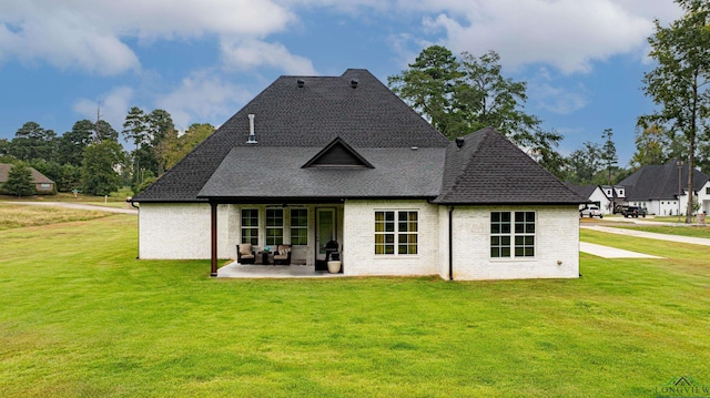 back of house with a patio area and a yard