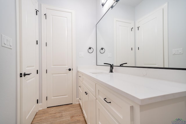 bathroom with vanity and hardwood / wood-style flooring