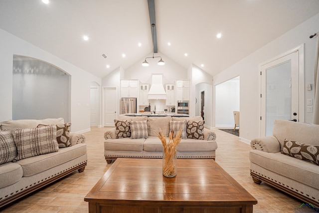 living room with sink, beamed ceiling, and high vaulted ceiling