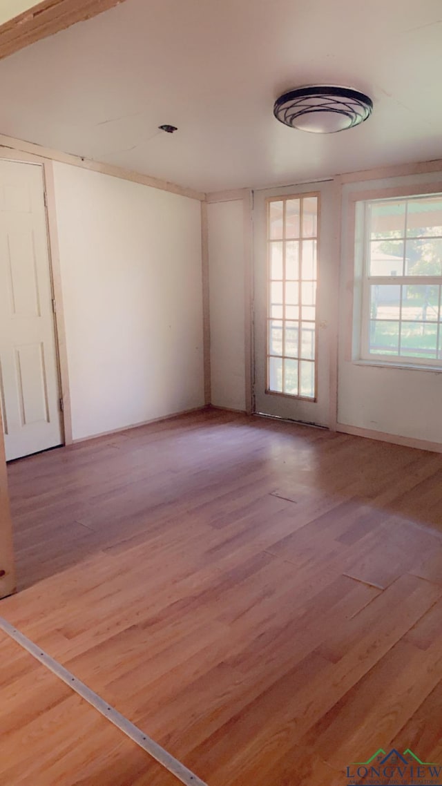 unfurnished room with wood-type flooring