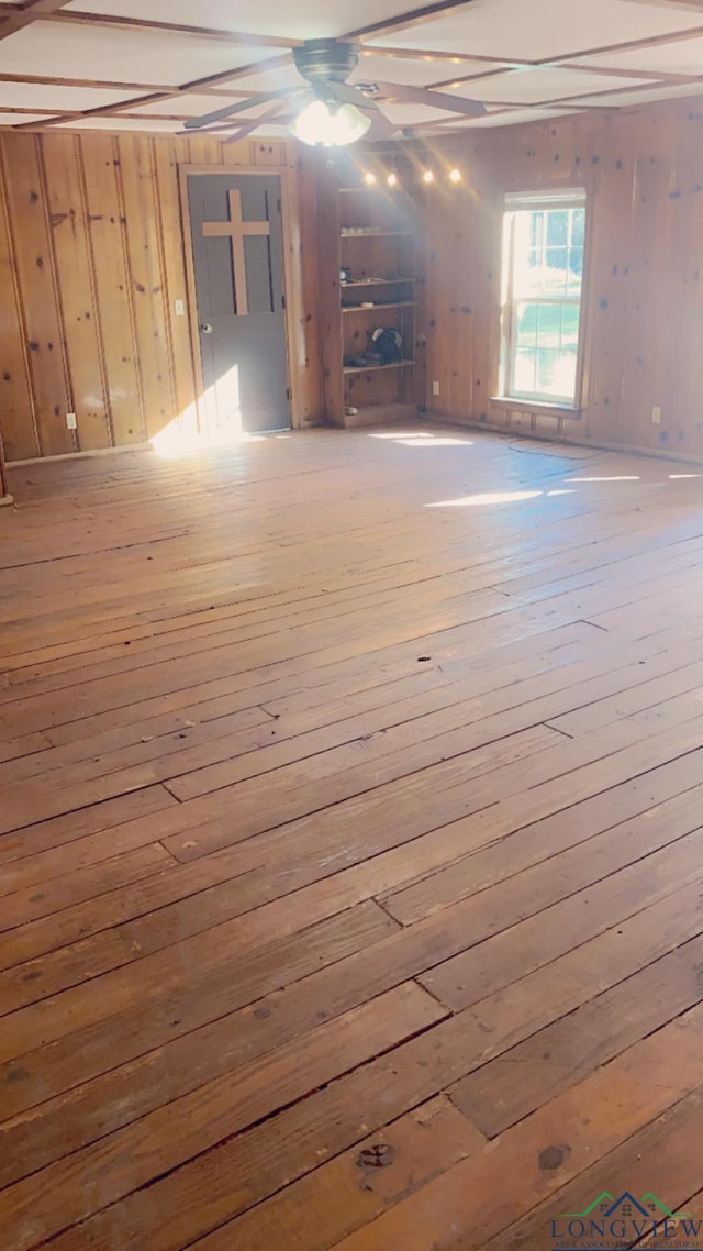 basement featuring ceiling fan and light wood-type flooring