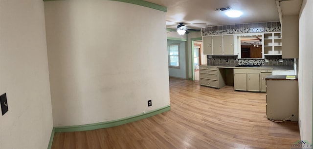 kitchen featuring backsplash, gray cabinets, ceiling fan, and light hardwood / wood-style flooring