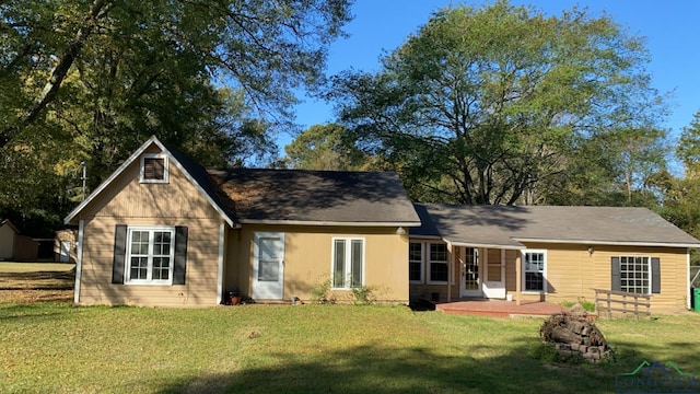 back of house with a lawn