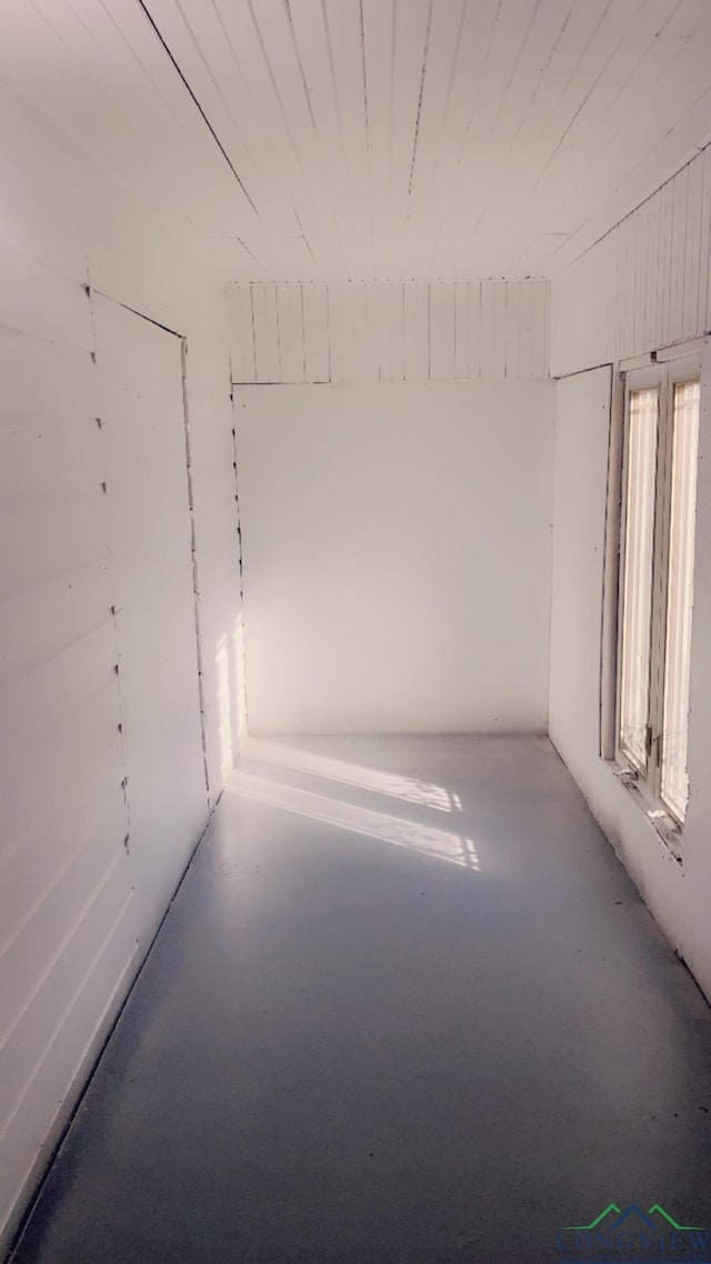 unfurnished room featuring a healthy amount of sunlight and concrete flooring