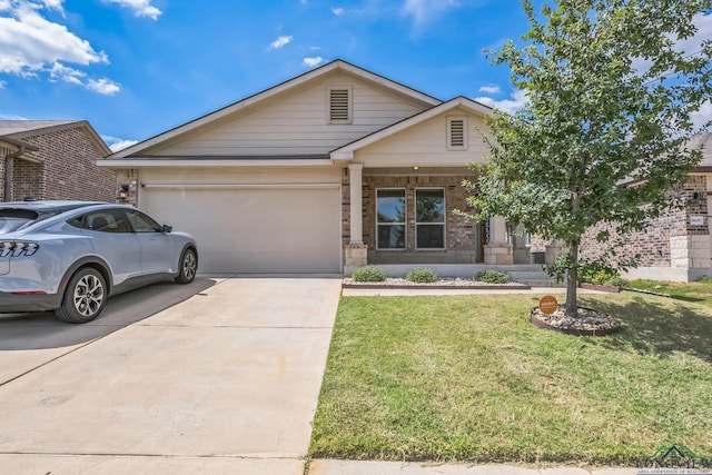 view of front of house featuring a garage and a front yard