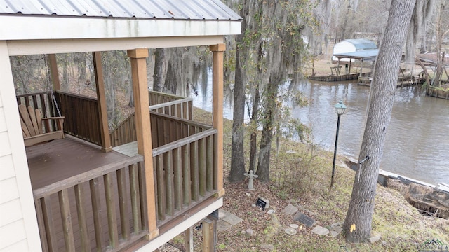 exterior space with a water view and a dock