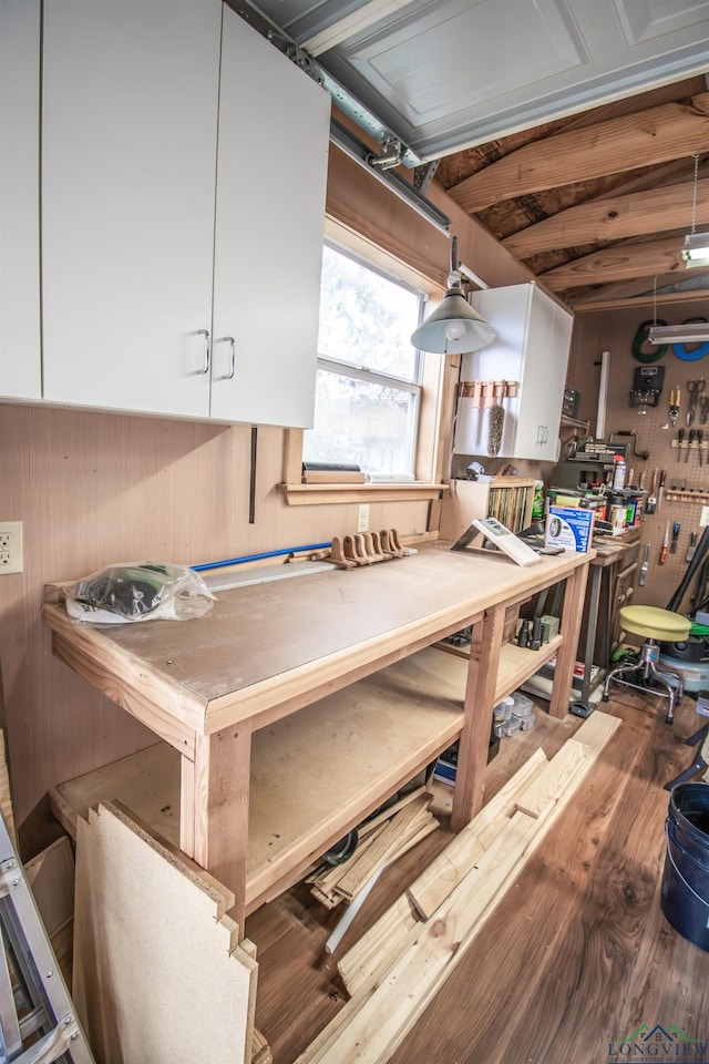 interior space featuring a workshop area and dark hardwood / wood-style flooring