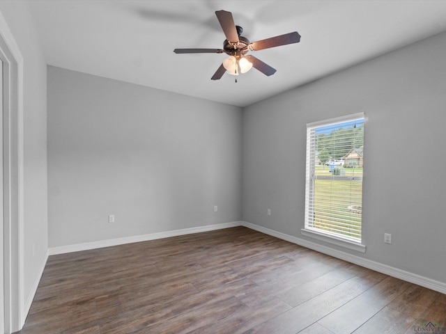 empty room with dark hardwood / wood-style floors and ceiling fan