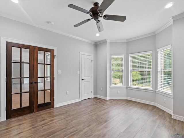 spare room featuring ceiling fan, light wood-type flooring, crown molding, and french doors