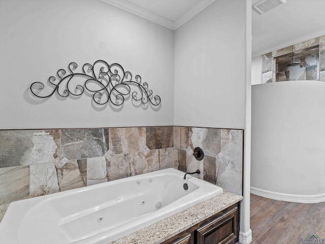 bathroom with hardwood / wood-style floors, ornamental molding, and a tub