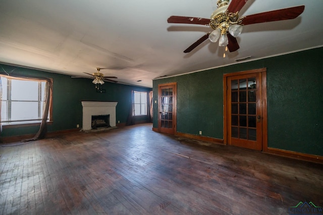 unfurnished living room featuring dark hardwood / wood-style floors, ceiling fan, and a brick fireplace