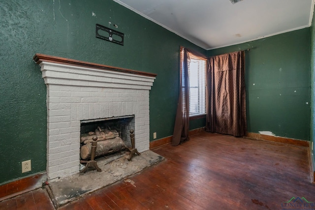 unfurnished living room with wood-type flooring, a fireplace, and ornamental molding