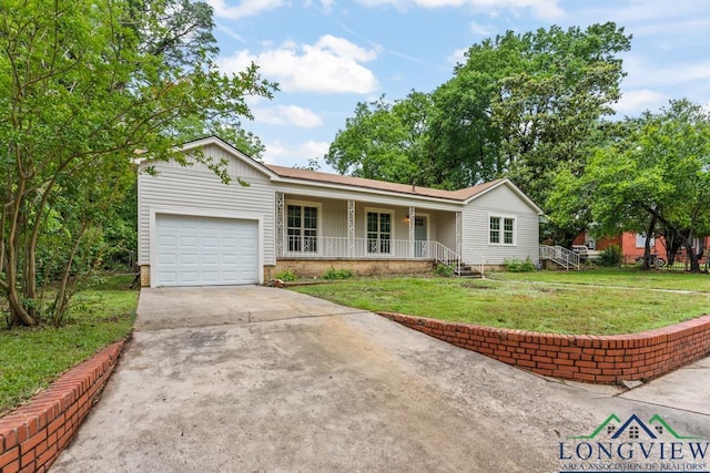 ranch-style home featuring driveway, an attached garage, a porch, and a front lawn