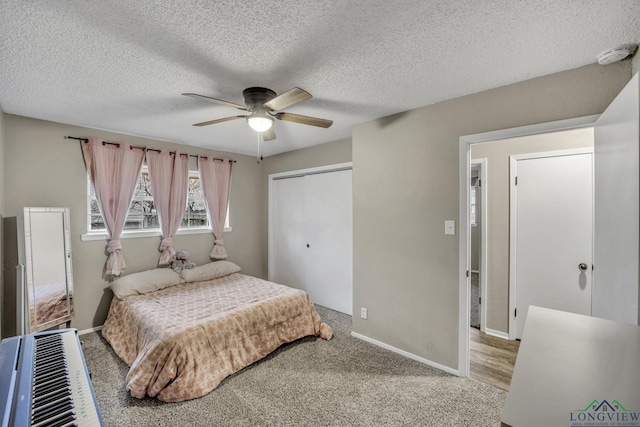 bedroom featuring a textured ceiling, carpet floors, a closet, and ceiling fan