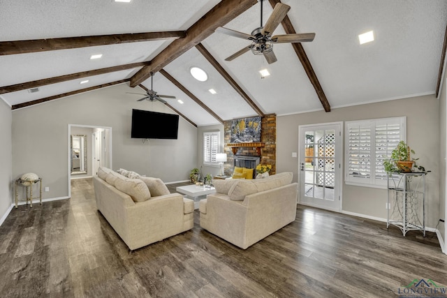 living room featuring dark hardwood / wood-style floors, a fireplace, lofted ceiling with beams, and a textured ceiling