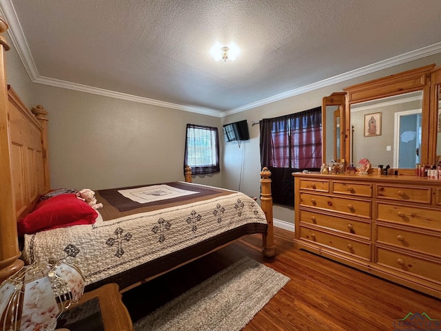 bedroom featuring hardwood / wood-style flooring, ornamental molding, and a textured ceiling