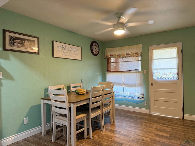 dining space featuring dark hardwood / wood-style floors and ceiling fan