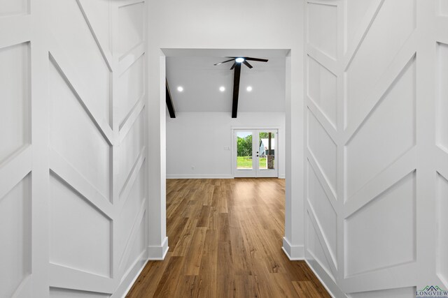 hall featuring dark wood-type flooring, baseboards, vaulted ceiling with beams, and french doors