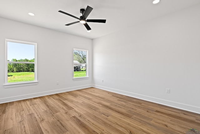 unfurnished room with baseboards, recessed lighting, and wood finished floors